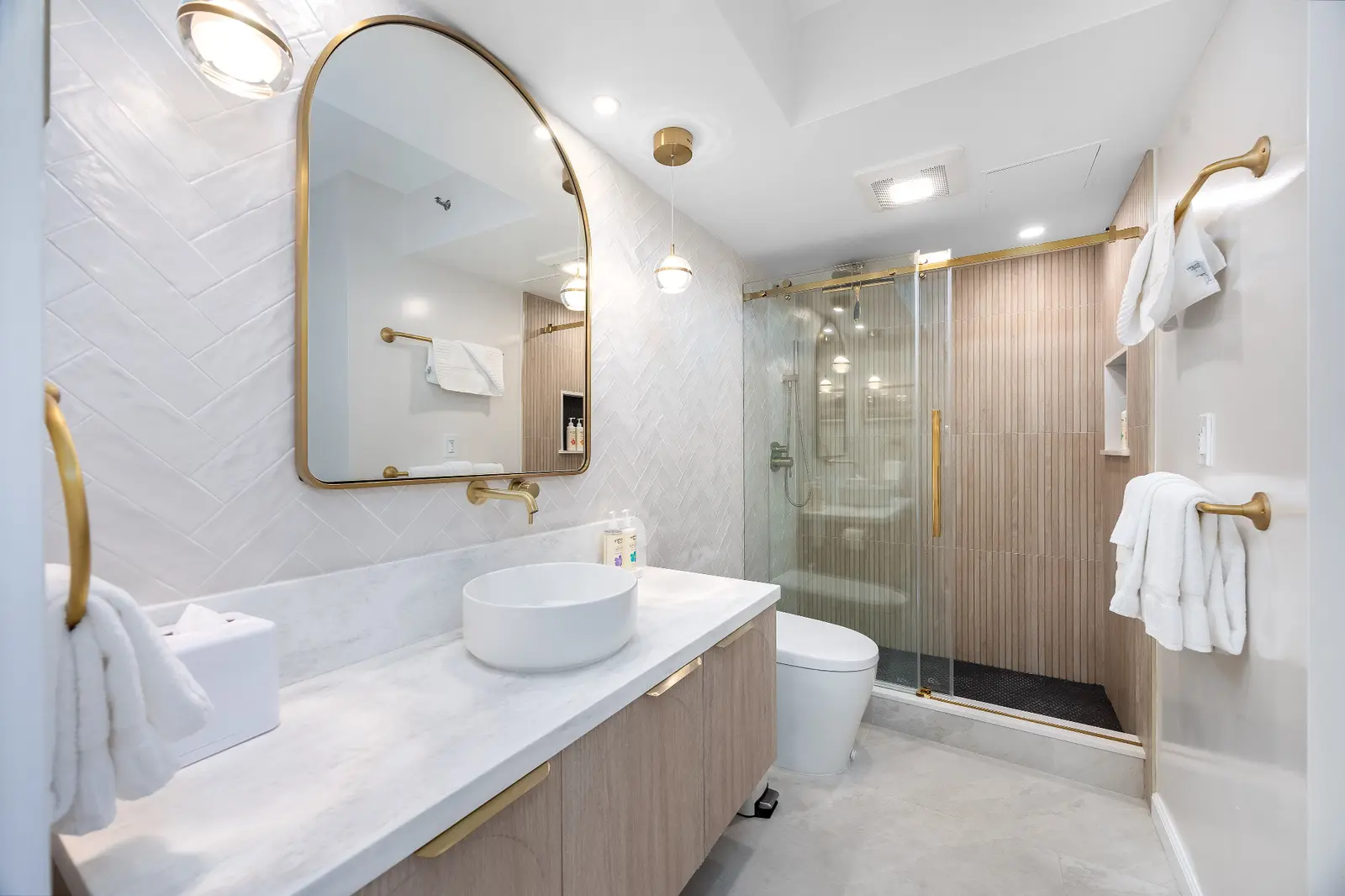 Bright vacation rental bathroom prepared with clean towels for guest arrival